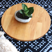 Mesa redonda de madera de lenga - macetero de cemento de forma de corazon con planta.jpg