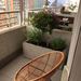Jardinera de cemento de 100 x 40 - jardinera de cemento de 100x40x40 cm con plantas y silla de mimbre modelo chincol.jpeg