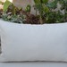 Cojín decorativo de exterior premium de 70 por 35 cm - cojin crudo con flecos de exterior.jpg