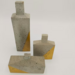 Esculturas de hormigón - botellones esculturales de hormigon cemento con toque dorado elemento decorativo nordico.png